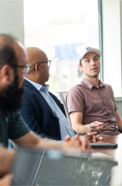 3 co-workers having a discussion seated at the table