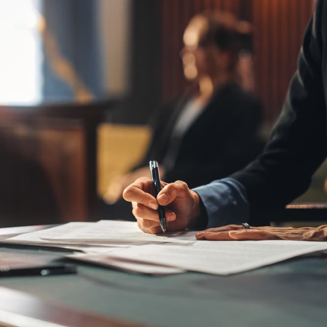 Man filling out a handwritten document. 