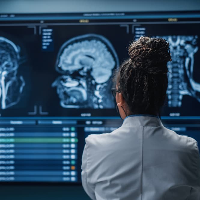 Woman looking at brain scans.